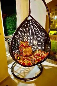 a wire basket filled with colorful packets on a porch at Madinaty Gardens in Madinaty
