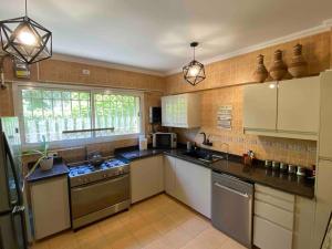 a large kitchen with white cabinets and appliances at Madinaty Gardens in Madinaty