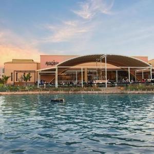 a building with a pool of water in front of it at Madinaty Gardens in Madinaty