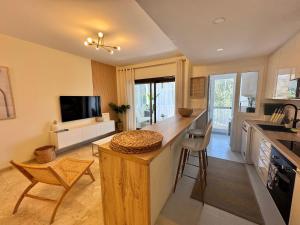 a kitchen with a counter and a tv in it at Puerto De La Duquesa in Manilva