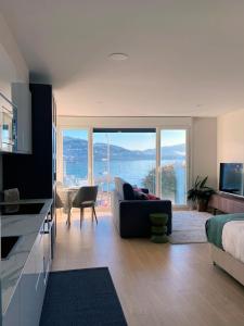 a living room with a couch and a large window at Alojamientos Ría de Vigo & Alborada in Moaña +15 photos