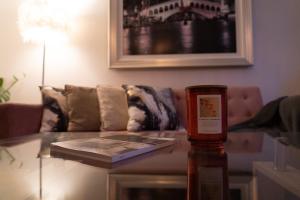 a bottle of wine on a glass table in a living room at Central Home in Portsmouth Sleeps 10 in Portsmouth +16 photos