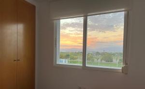 a window in a room with a view of a sunset at Moncofa Sunset in Moncófar