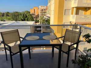 a blue table and two chairs on a balcony at Moncofa Sunset in Moncófar
