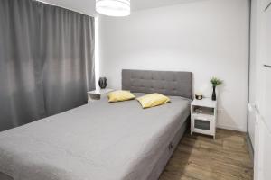 Postel nebo postele na pokoji v ubytování Figlo Apartment