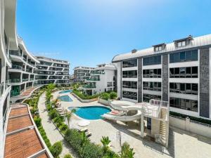 an apartment complex with a swimming pool and buildings at Sol Garden Residence F16 in Alanya