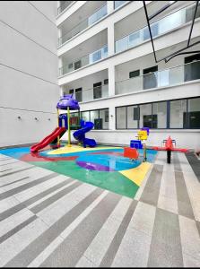 a playground in front of a building with a building at Eika - Refined and luxurious studio Apartment in Nairobi