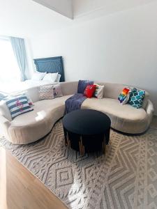 a living room with a couch and a table at Eika - Refined and luxurious studio Apartment in Nairobi +18 photos