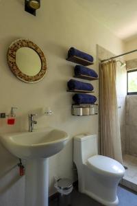 a bathroom with a sink and a toilet and a mirror at Condo Temis Vallarta in Puerto Vallarta