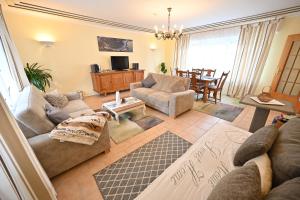 a living room with couches and a dining room at Apartment Paradiso in Kelberg