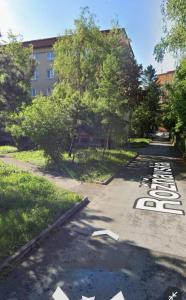 an empty street with trees and a building at Apartman Cañas Modrá Víla in Rimavská Sobota +9 photos