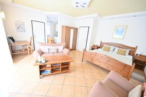 a living room with a bed and a couch at Apartment Paradiso in Kelberg