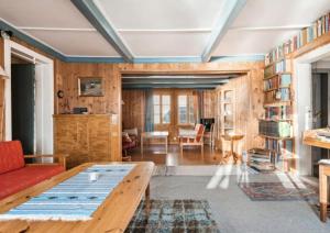 a living room with a couch and a table at Lofoten Farm House in Vestvågøya