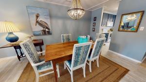 a dining room with a wooden table and chairs at Edisto on my Mind in Edisto Island