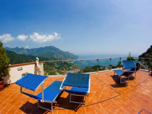 a group of blue chairs sitting on a roof at Hotel Bonadies in Ravello