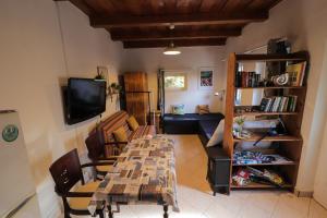 a living room with a table and a tv at Palócliget Vendégház in Kétbodony