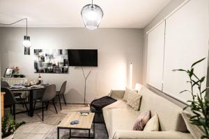 a living room with a couch and a table at Hermes Modern Apartment in Alexandroupoli