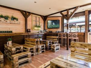 a room with wooden walls and a bar with wooden crates at Cottage in azy near Beach and Lake Jamno in Łazy