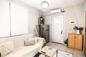a living room with a couch and a table at Hermes Modern Apartment in Alexandroupoli
