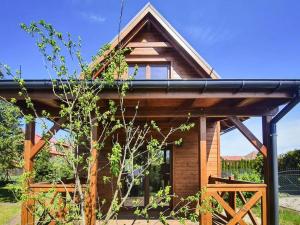 a wooden house with a black roof at holiday home in Stepnica for 6 persons in Stepnica