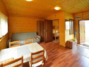 a room with a table and chairs in a room at Cottage in Rusinowo near Seaside Beach in Rusinowo