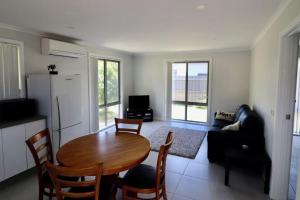 a kitchen and living room with a table and chairs at 36 Betka Road in Mallacoota