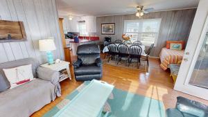 a living room with a couch and a table at Fooses Folly in Folly Beach