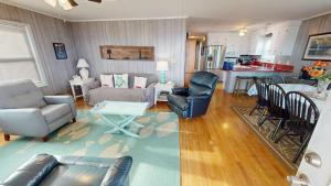 a living room with a couch and chairs and a table at Fooses Folly in Folly Beach