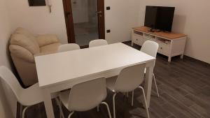a living room with a white table and chairs at House in Sardegna in Triei