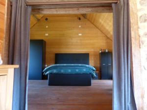 a bedroom with a bed with blue pillows at Eco-grange au milieu de notre ferme biologique O'Naturel in Massat