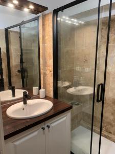 a bathroom with a sink and a shower at Au pied des Alpilles in Paradou +10 photos