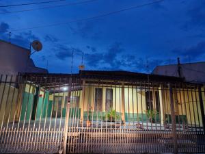 a building with a fence in front of it at Apto próx ao Shopping in Rondonópolis +1 photo