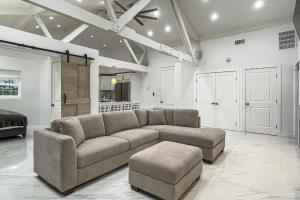 a large living room with a couch and a stool at Cozy Cottage in Cos Cob in Greenwich