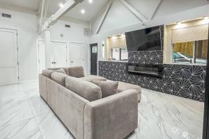 a living room with a couch and a flat screen tv at Cozy Cottage in Cos Cob in Greenwich +22 photos