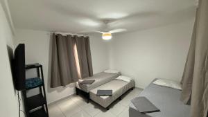 Postel nebo postele na pokoji v ubytování Sossai Hostel Flats