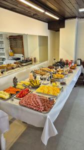 a buffet line with many different types of food at Hotel Fênix in Florianópolis