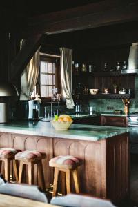 a kitchen with a counter with a bowl of fruit on it at Chalet de Luxe Saint Gervais avec Vue ,Spa, Jacuzzi, Salle de sport in Saint-Gervais-les-Bains