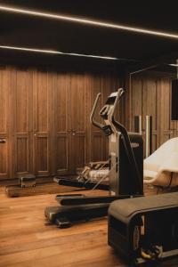 a gym with a treadmill on a wooden floor at Chalet de Luxe Saint Gervais avec Vue ,Spa, Jacuzzi, Salle de sport in Saint-Gervais-les-Bains