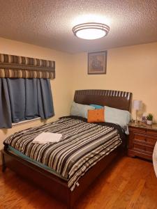 a bedroom with a bed and a window and a nightstand at Mozzy-Love Room in Orlando