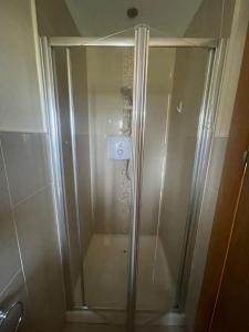 a shower with a glass door in a bathroom at 3 Bed Hse Esker Hills Golf Club 018 in Ballynasrah +4 photos