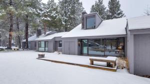 a house in the snow with a bench at Meadow House - Unit 56 in Sunriver