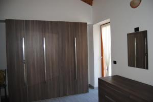 a large wooden closet in a room with a dresser at Casa da Giorgia in Lezzeno