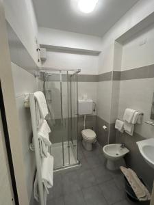 a bathroom with a shower and a toilet and a sink at Hotel Marchina in Brescia +49 photos