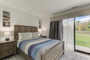 a bedroom with a bed and a large window at Gorgeous Chic Beach Front Condo 2775 in Traverse City
