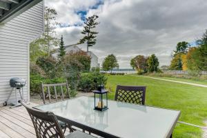 a table and chairs on a patio with a yard at Gorgeous Chic Beach Front Condo 2775 in Traverse City