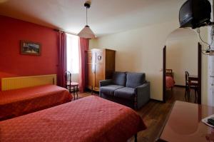 a hotel room with two beds and a chair at Hostal Ayestaran I in Lekunberri +38 photos