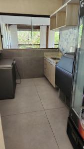 an empty kitchen with a sink and a window at Casa em Praia do Forte Refúgio Luxo e Natureza in Praia do Forte