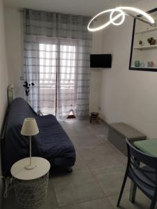 a bedroom with a bed and a table with a lamp at Appartamento Mare Blu in Martinsicuro