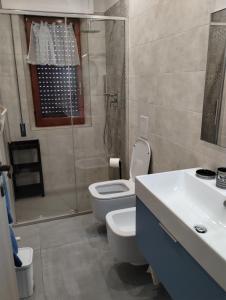 a bathroom with a shower and a toilet and a sink at Appartamento Mare Blu in Martinsicuro