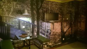 a balcony with a tv on a wall at Motel Caldas in Caldas de Reis